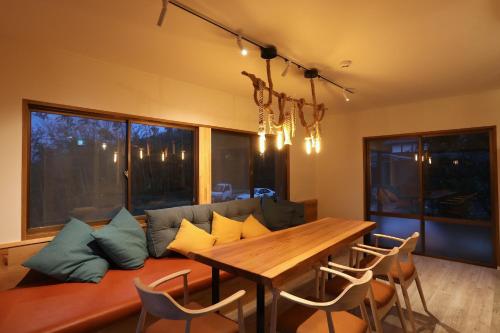 a living room with a couch and a wooden table at Kaira no Teitaku - Vacation STAY 63757v in Iwase
