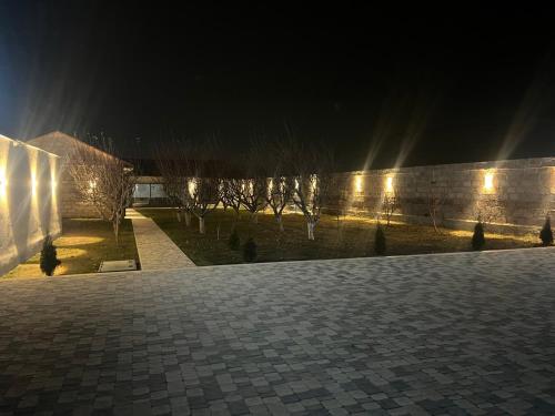 a courtyard at night with lights on a wall at Rizo rest zone in Kotaykʼ