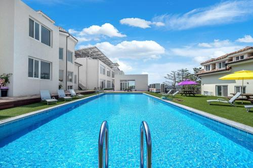 a swimming pool in the backyard of a house at Goseong Belloci Kids Poolivilla in Goseong