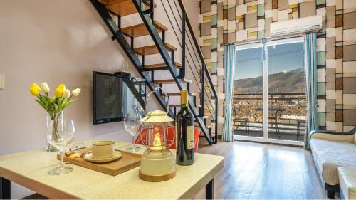 a room with a table with wine glasses and a staircase at Gapyeong Lemon Pension in Gapyeong