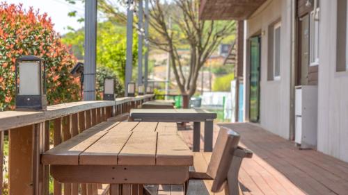 a row of wooden benches on a porch at suncheon romance pension in Suncheon