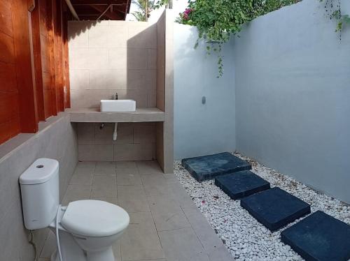 un baño con inodoro y lavabo en Welly Bungalow, en Gili Trawangan