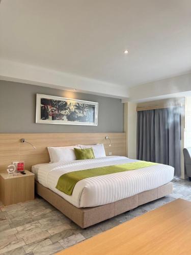 a bedroom with a large bed in a room at iCheck inn Thapra in Bangkok