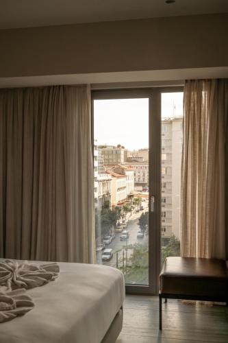 Ένα ή περισσότερα κρεβάτια σε δωμάτιο στο VISION OMONIA, ATHENS