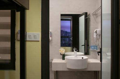 a bathroom with a white sink and a mirror at Hanoi Oldtown Nomad Hostel in Hanoi