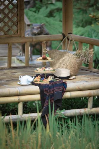 a table with food and a basket on a deck at Lawani Resort in Tegalalang