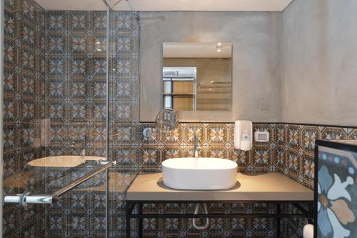 a bathroom with a sink and a mirror at Haifa Peak in Haifa