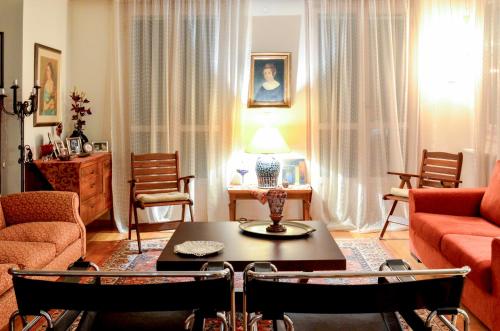 a living room with a couch and a table and chairs at Aesthetic Delight - Stone Villa in Mystras in Mystras