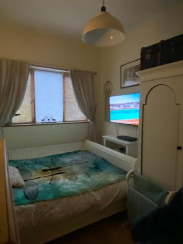 a bedroom with a bed and a flat screen tv at King Comfort tv microwave fridge in Upton