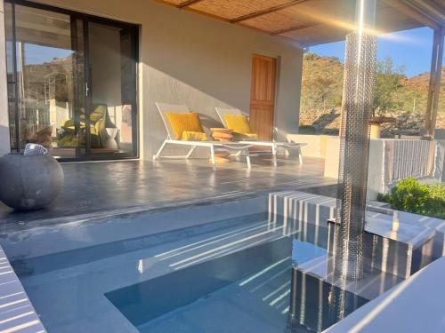 a house with a swimming pool and a patio at Aardvark Bioreserve in Ladismith