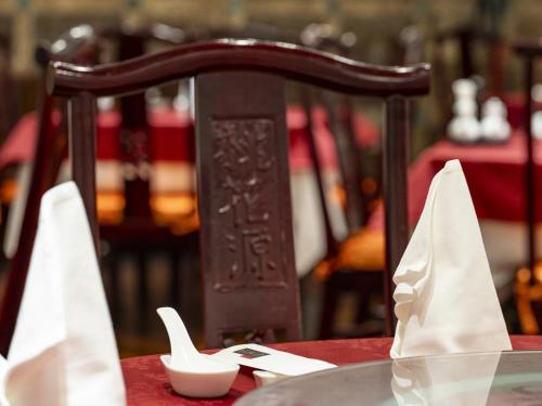 a wooden chair with napkins on a table at Kumamoto Hotel Castle in Kumamoto