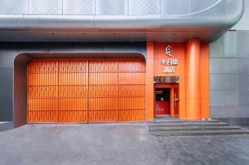 an orange door on a building with two entrances at Banyueli Hotel in Shanghai