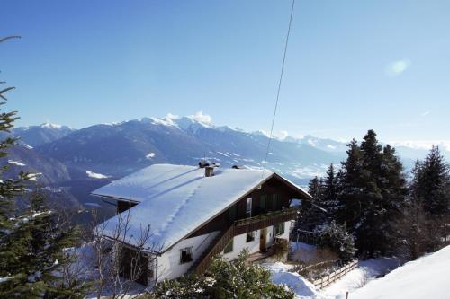 a house with a snow covered roof on a mountain at Traterhof-Spinges in Mühlbach