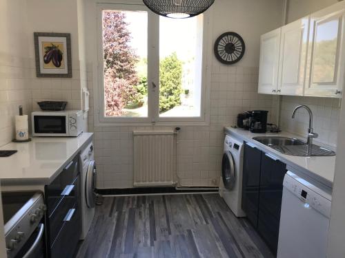 une cuisine avec un évier et une machine à laver dans l'établissement Escapade bord de mer, à Sainte-Adresse