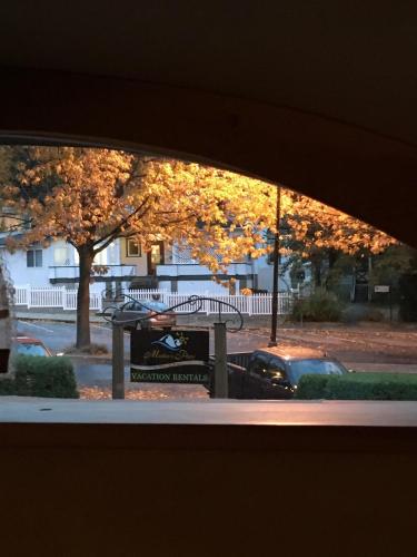 a window view of a picnic table and trees at Mistiso's Place Vacation Rentals in Nelson