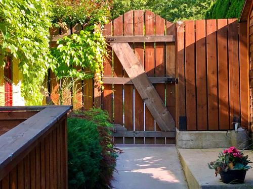 a wooden fence with a wooden gate with a wooden door at Mistiso's Place Vacation Rentals in Nelson
