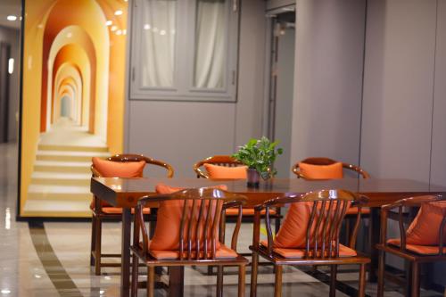 a dining room with a wooden table and chairs at Banyueli Hotel in Shanghai