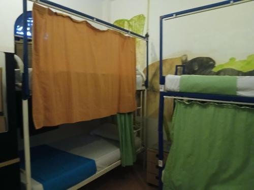 a room with two bunk beds and a curtain at Seconds Hostel - Colombo in Colombo