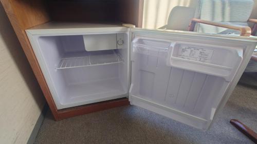 a small white refrigerator with its door open at Select Inn Yaizu Ekimae in Yaizu