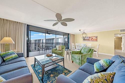 a living room with blue couches and a table at Sundial P401 in Sanibel