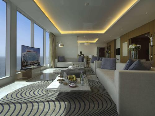 a living room with a couch and a table at Novotel Jazan in Jazan