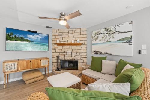 a living room with a couch and a fireplace at Rabbit Retreat in Sanibel