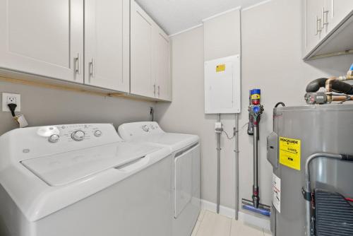 a white laundry room with a washer and dryer at Rabbit Retreat in Sanibel