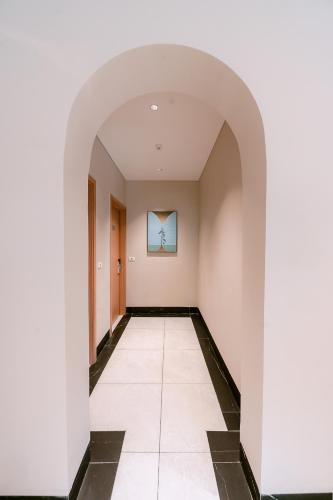an empty hallway with white walls and a tile floor at Lam Anh Hotel 8 Ngoại Giao Đoàn BT3-10 in Hanoi