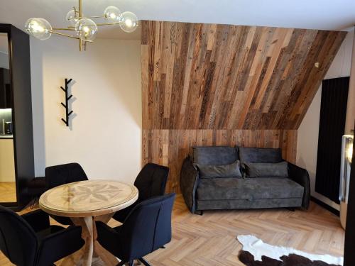 a living room with a couch and a table at Zwierzyniecka Residence in Zakopane