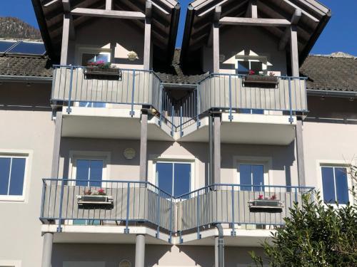 two balconies on a building with flowers on them at Appartment Isabelle - Kamille in Presseggersee