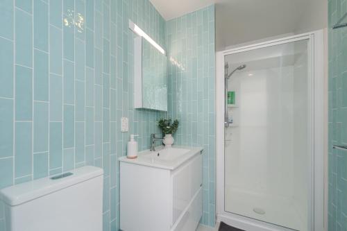a bathroom with a toilet and a sink at The Terrace CBD Apt for Work & Play in Wellington