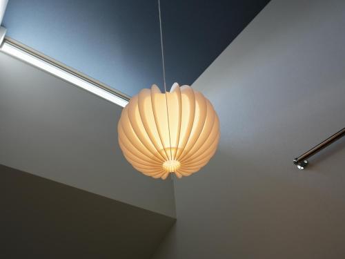 a lamp hanging from a ceiling in a room at OUCHI HOTEL Onaganishi in Hiroshima