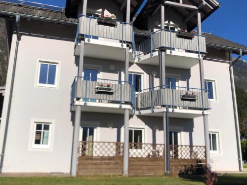 a white building with balconies on the side of it at Appartment Isabelle Sky in Presseggersee