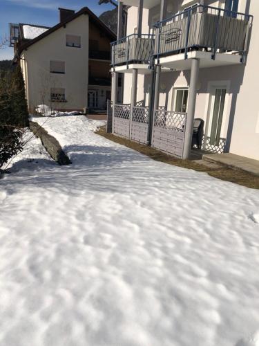 a pile of snow in front of a house at Appartment Isabelle Sky in Presseggersee