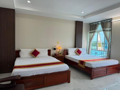 Postel nebo postele na pokoji v ubytování Thành Đạt Hotel Bạc Liêu