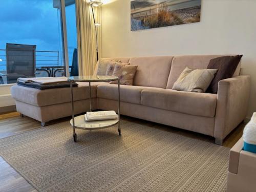 a living room with a couch and a coffee table at Apartment Ostseeblick 131 in Timmendorfer Strand