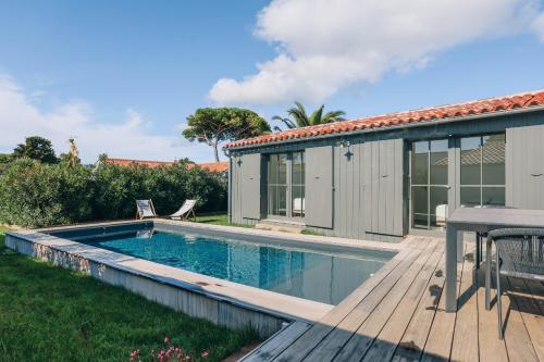 une piscine sur une terrasse à côté d'une maison dans l'établissement Villa Berry, au Bois-Plage-en-Ré