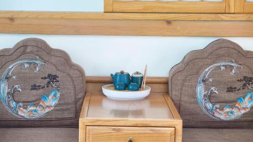 two chairs sitting next to a table with a bowl on it at Avatar Hilltop Manor B&B in Zhangjiajie