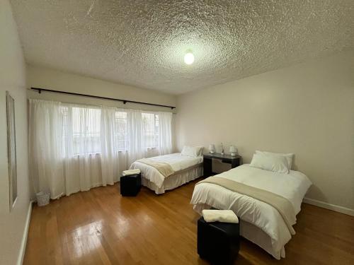 a bedroom with two beds and a window at Robridon in Summerstrand