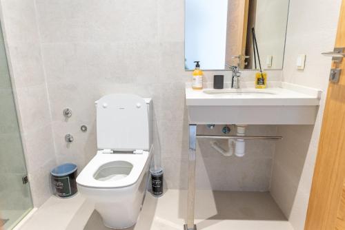 a bathroom with a white toilet and a sink at The lodge Residence by Goodmove - Hay Riad in Rabat