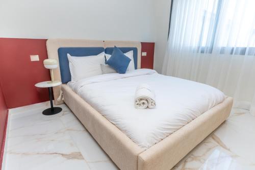 a bedroom with a bed with a dog on it at The lodge Residence by Goodmove - Hay Riad in Rabat