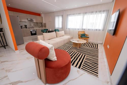 a living room with a couch and a chair at The lodge Residence by Goodmove - Hay Riad in Rabat