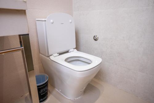 a bathroom with a white toilet in a stall at The lodge Residence by Goodmove - Hay Riad in Rabat
