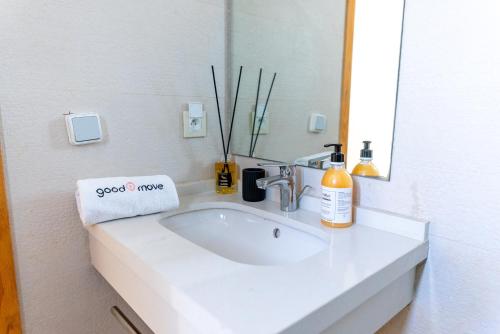 a bathroom with a white sink and a mirror at The lodge Residence by Goodmove - Hay Riad in Rabat
