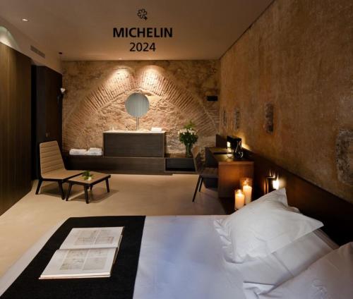 a bedroom with a bed and a living room at Caro Hotel in Valencia