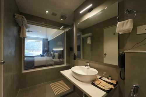 a bathroom with a sink and a mirror at Ikshana Resort and Spa, Khandala in Lonavala
