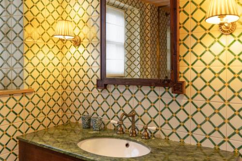 a bathroom with a sink and a mirror at Hôtel Saint-Georges in Megève
