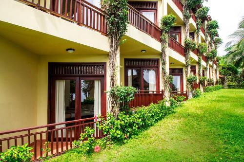 a building with plants on the side of it at Romana Resort & Spa in Mui Ne