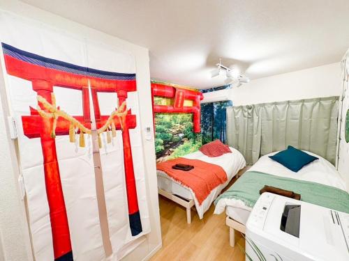 a bedroom with a bed in a room with a window at LEON RESORT HOTEL B 4rooms MAX14people 6min Shinjuku 11min Shibuya 12min walk Ikebukuro LEON RESORT IKEBUKURO traditional Japanese room 池袋 最大14名 in Tokyo