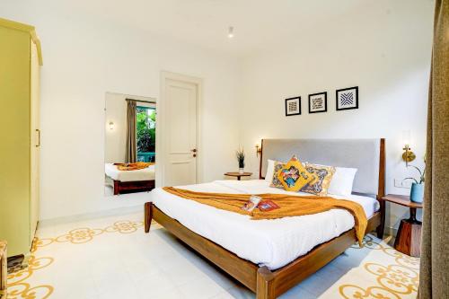 a bedroom with a large bed in a room at Valencia By DanCenter - 3 Bhk Villa in Siolim in Siolim